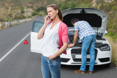 woman calling insurance for broken down car